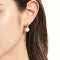 Model wearing Solitaire Cultured Pearl Stud Earrings in Sterling Silver, Yellow Gold Flashed