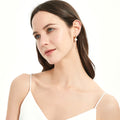 Model wearing Solitaire Cultured Pearl Stud Earrings in Sterling Silver, Yellow Gold Flashed