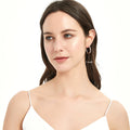 Model wearing Bar CZ Medium Hoop Earrings in Sterling Silver, 1 inch