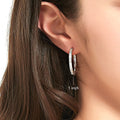 Model wearing Bar CZ Medium Hoop Earrings in Sterling Silver, 1 inch