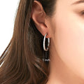 Model wearing Bar CZ Medium Hoop Earrings in Sterling Silver, 1 inch