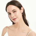 Model wearing CZ Medium Inside-Out Hoop Earrings in Sterling Silver 1 inch, Yellow Gold Flashed