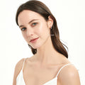 Model wearing Bar CZ Medium Hoop Earrings in Sterling Silver, 0.6 inch