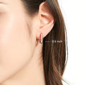 Model wearing Bar CZ Medium Hoop Earrings in Sterling Silver, 0.6 inch