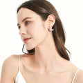 Model wearing Feather CZ Necklace and Earrings in Sterling Silver, Rhodium Plated