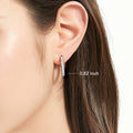 Model wearing Bar CZ Medium Hoop Earrings in Sterling Silver, 0.6 inch