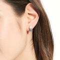 Model wearing Solitaire Clam Cultured Pearl Stud Earrings in Sterling Silver, Rhodium Plated