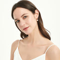 Model wearing Solitaire Cultured Pearl Stud Earrings in Sterling Silver, Yellow Gold Flashed