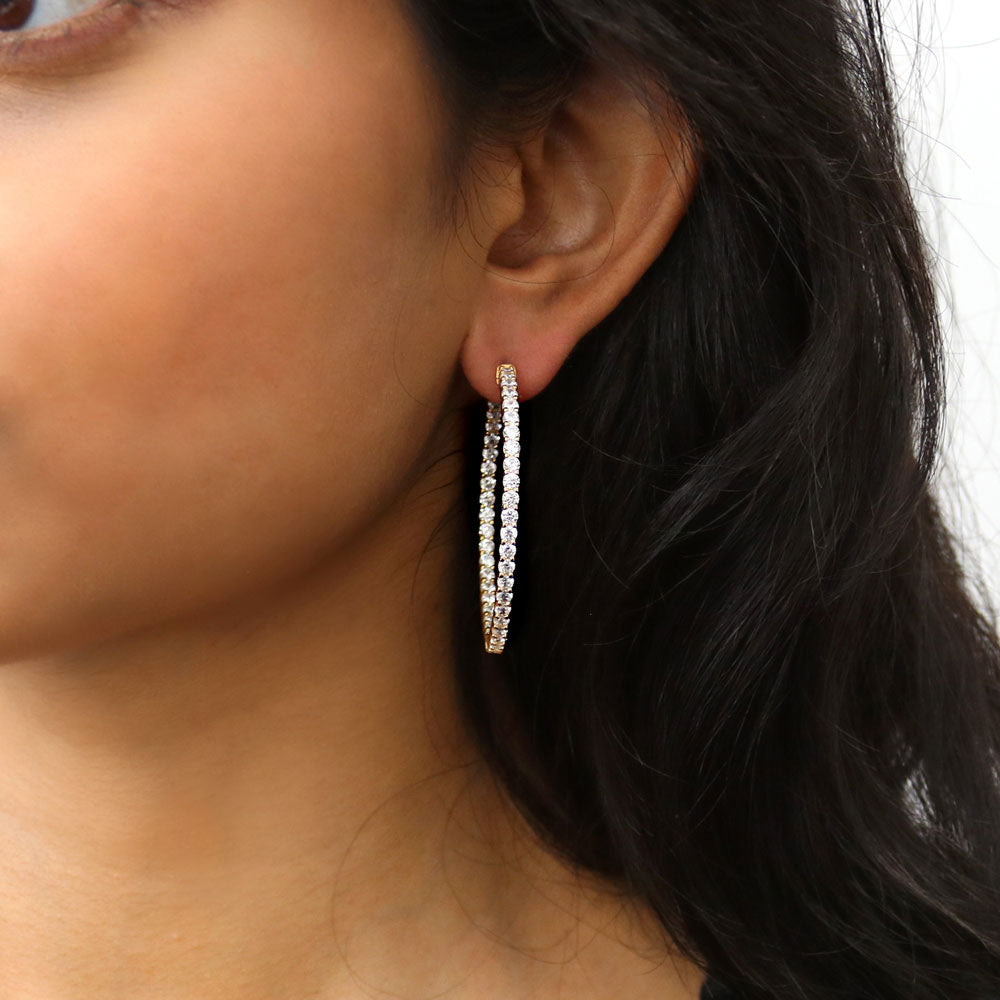 Model wearing CZ Inside-Out Hoop Earrings in Sterling Silver 1.8 inch, Yellow Gold Flashed