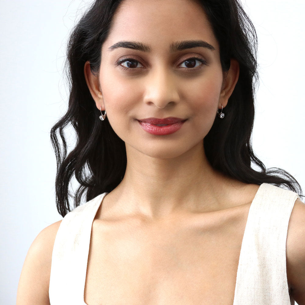 Model wearing Solitaire 1.2ct Bezel CZ Leverback Earrings in Sterling Silver, Rose Gold Flashed