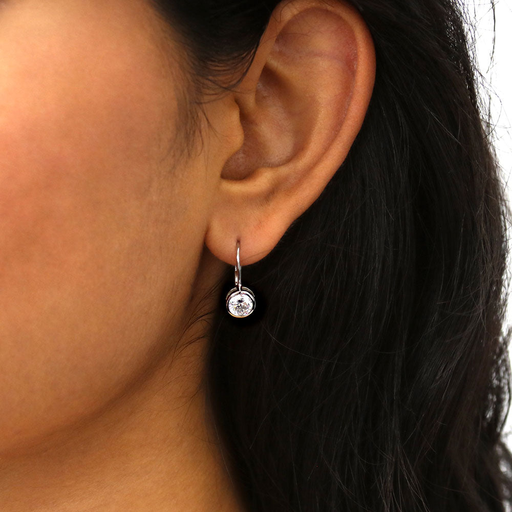 Model wearing Solitaire 1.2ct Bezel CZ Leverback Earrings in Sterling Silver, Yellow Gold Flashed