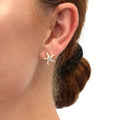 Model wearing Starfish CZ Stud Earrings in Sterling Silver, Yellow Gold Flashed