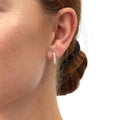 Model wearing Rectangle CZ Medium Hoop Earrings in Sterling Silver 0.62 inch, Yellow Gold Flashed