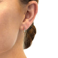 Model wearing Rectangle CZ Mini Hoop Earrings in Sterling Silver 0.46 inch, Yellow Gold Flashed