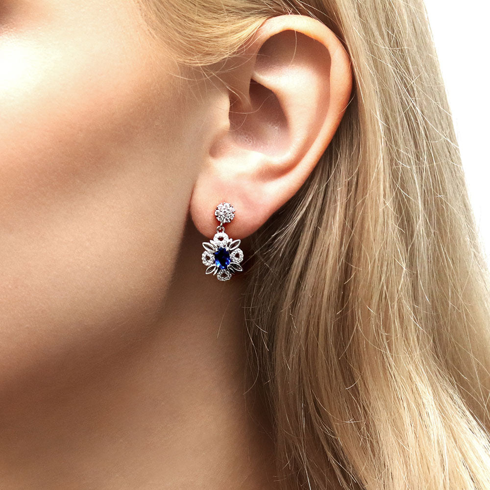 Model wearing Flower Halo Sapphire-Blue CZ Earrings in Sterling Silver, 2 of 6