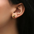 Model wearing Love Knot Stud Earrings in Sterling Silver, Yellow Gold Flashed