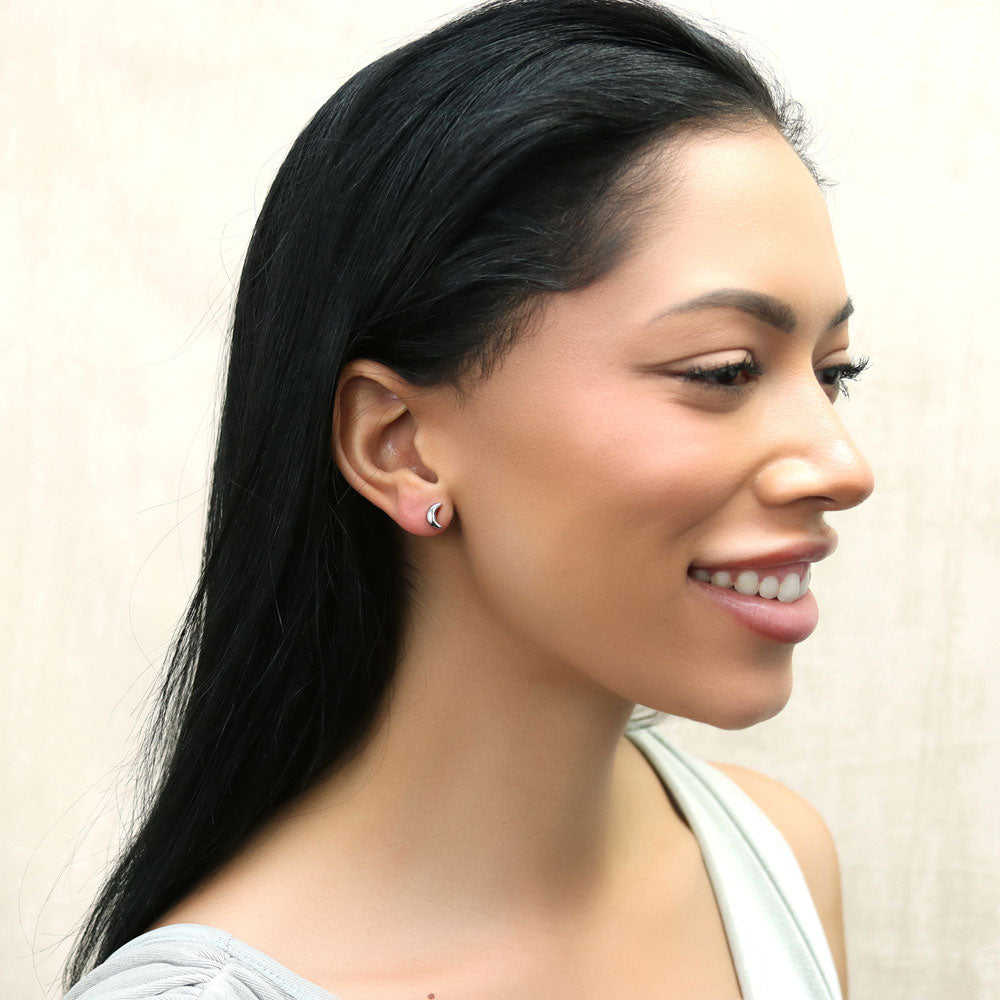 Model wearing Crescent Moon Cartilage Stud Earrings in Sterling Silver, Yellow Gold Flashed