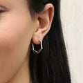 Model wearing Hexagon CZ Inside-Out Hoop Earrings in Sterling Silver 0.8 inch, Rhodium Plated