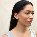 Model wearing Solitaire Bezel CZ Stud Earrings in Gold Flashed Sterling Silver, 4mm