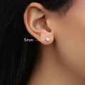 Model wearing Solitaire CZ Stud Earrings in Gold Flashed Sterling Silver, 5mm