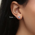 Model wearing Solitaire CZ Stud Earrings in Gold Flashed Sterling Silver, 7mm