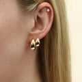 Model wearing Solitaire CZ Stud Earrings in Gold Flashed Sterling Silver, 4mm