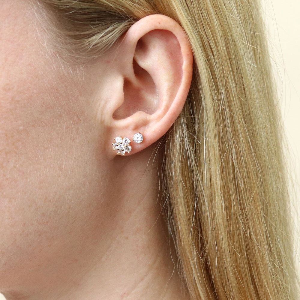 Model wearing Flower CZ Stud Earrings in Sterling Silver, Yellow Gold Flashed