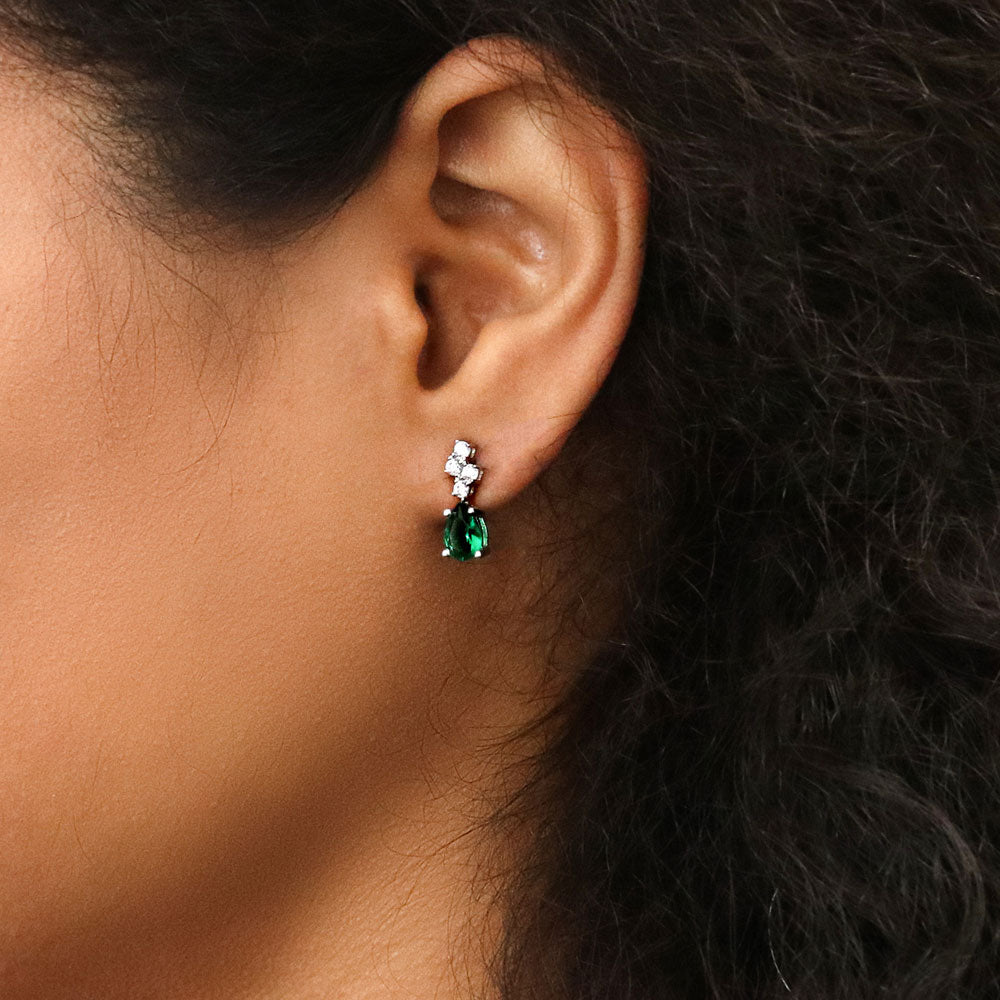Model wearing Cluster Emerald-Green CZ Stud Earrings in Sterling Silver, 2 of 5