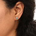 Model wearing Halo Pear CZ Stud Earrings in Sterling Silver, Green Color