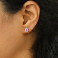 Model wearing Halo Pear CZ Stud Earrings in Sterling Silver, Purple Color