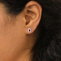 Model wearing Halo Pear CZ Stud Earrings in Sterling Silver, Red Color