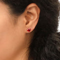 Model wearing Solitaire CZ Stud Earrings in Sterling Silver 1.6ct, Garnet Color