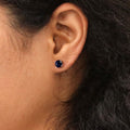 Model wearing Solitaire CZ Stud Earrings in Sterling Silver 1.6ct, Garnet Color