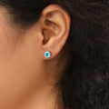 Model wearing Solitaire CZ Stud Earrings in Sterling Silver 1.6ct, Aquamarine Color