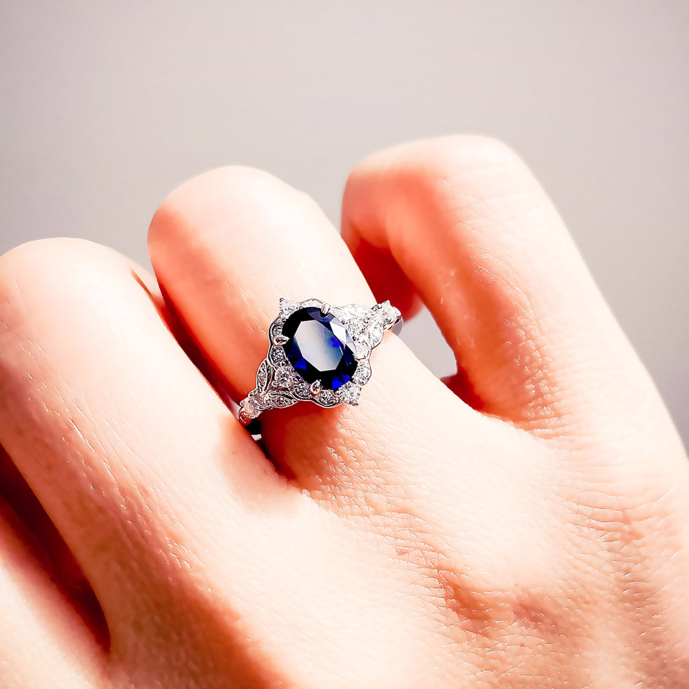 Model wearing Halo Art Deco Sapphire-Blue Oval CZ Ring in Sterling Silver, 9 of 10